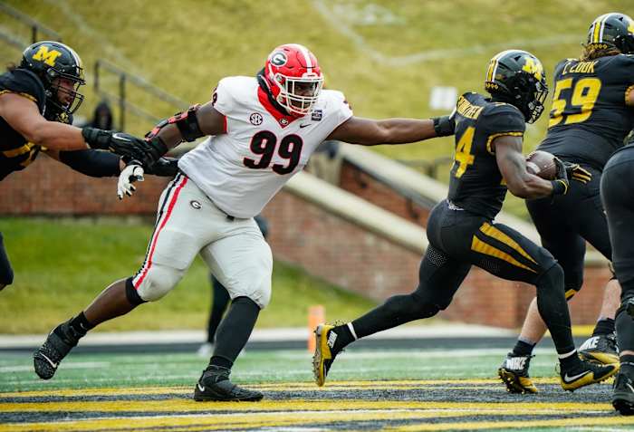 Dec 12, 2020; Columbia, Missouri, USA; Georgia Bulldogs defensive lineman Jordan Davis (99) defends against Missouri Tigers running back Larry Rountree III (34) during the first half at Faurot Field at Memorial Stadium. Mandatory Credit: Jay Biggerstaff-USA TODAY Sports